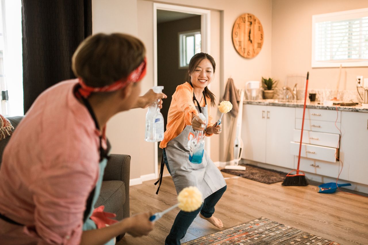 portfolio-03 Asian couple having fun while cleaning their home, enhancing a cheerful atmosphere.